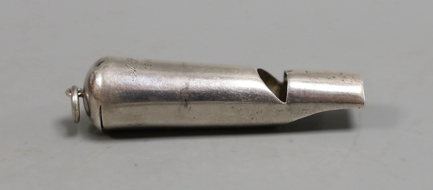 An early 20th century Chinese Export white metal whistle by Wang Hing, Hong Kong, 71mm.